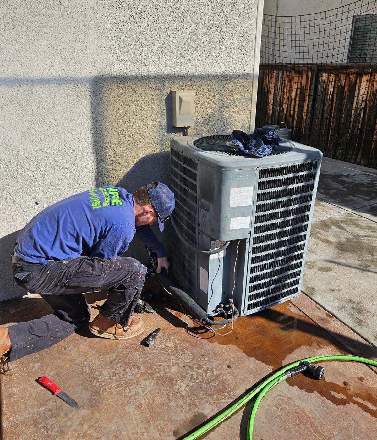 Airtime tech repairing HVAC unit